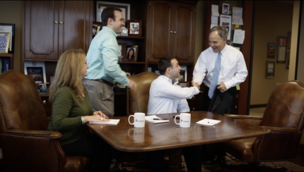 bill shaddock owner and ceo of capital title company shaking hands with man business team casual brown office